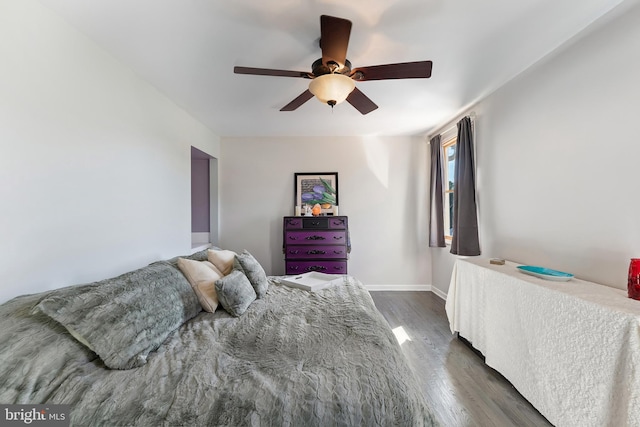 bedroom featuring ceiling fan and dark hardwood / wood-style flooring