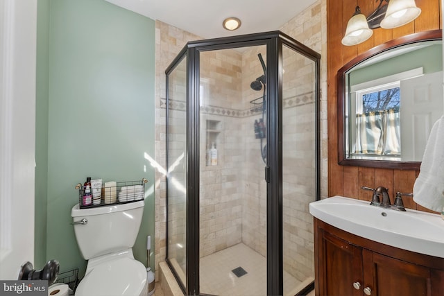 bathroom featuring vanity, toilet, and walk in shower