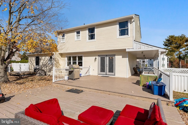 rear view of property with a wooden deck