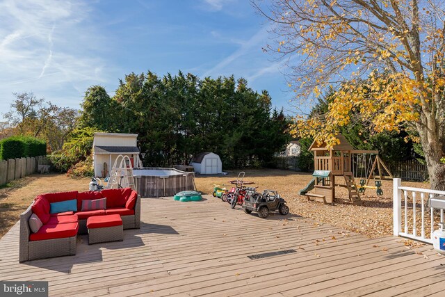 deck featuring outdoor lounge area, a storage shed, and a playground