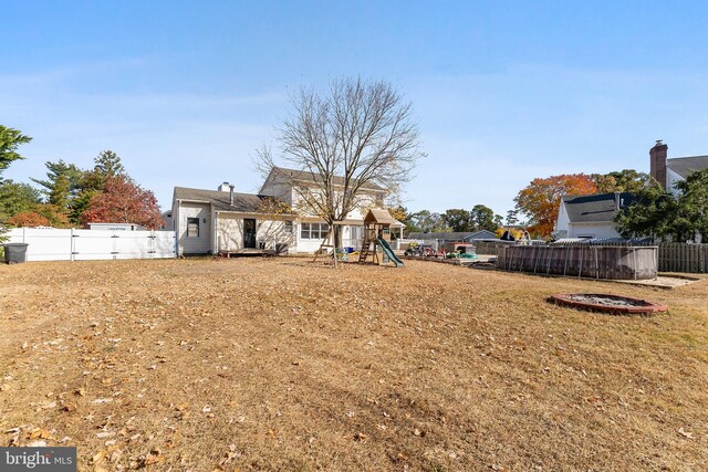 view of yard featuring an outdoor fire pit and a playground