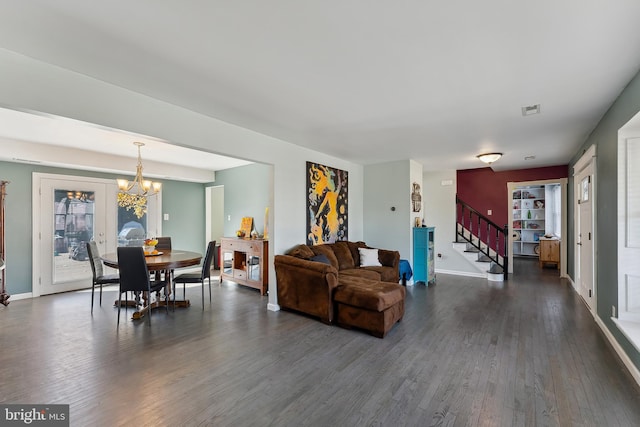 living room with a chandelier and dark hardwood / wood-style floors