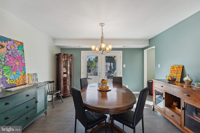 dining area featuring french doors, dark hardwood / wood-style floors, and a notable chandelier