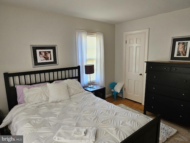 bedroom with wood-type flooring