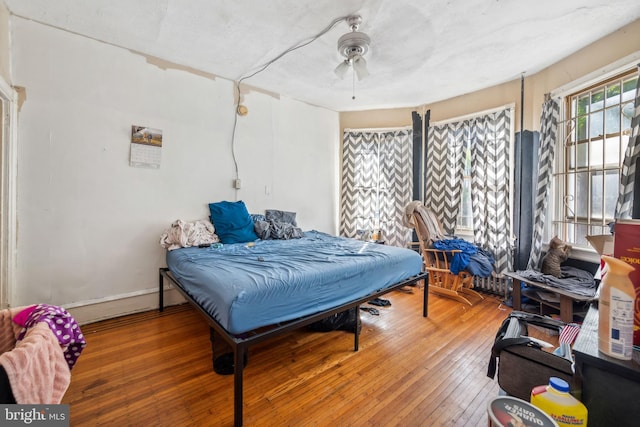 bedroom featuring hardwood / wood-style floors and ceiling fan