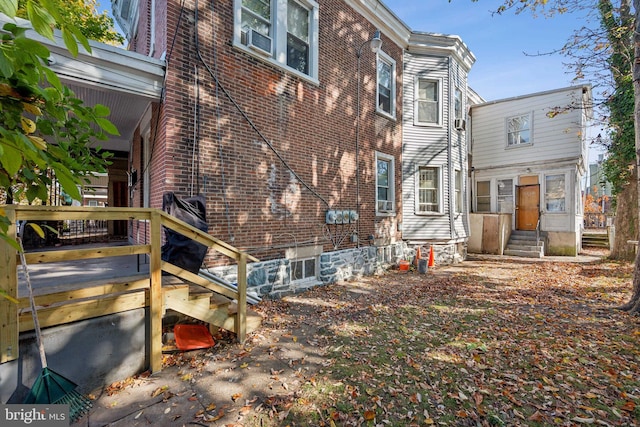 rear view of house featuring a wooden deck