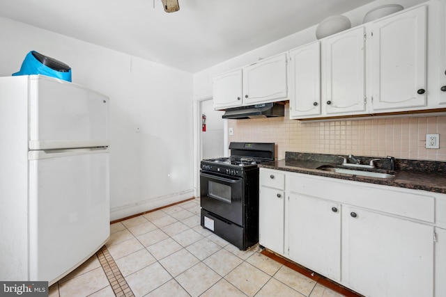 kitchen featuring black gas stove, backsplash, sink, white refrigerator, and white cabinets