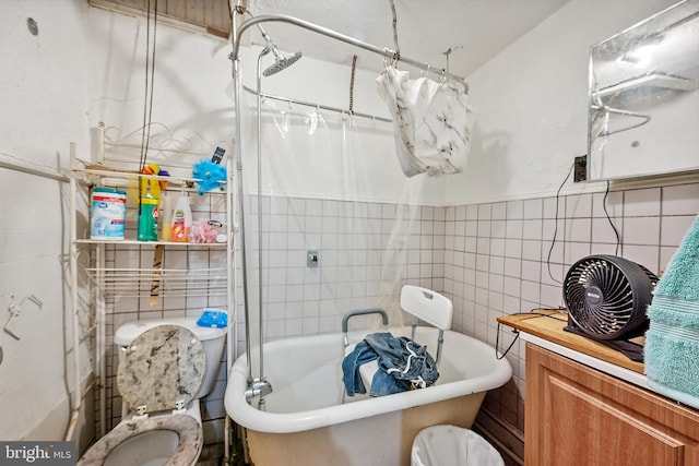 full bathroom with vanity, tile walls, shower / bath combo with shower curtain, and toilet