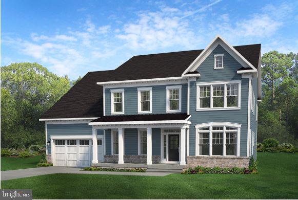 view of front of house with a front yard, covered porch, and a garage