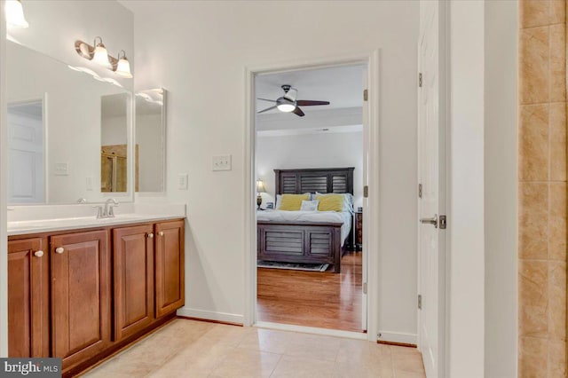 bathroom with vanity, hardwood / wood-style flooring, and ceiling fan