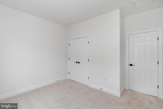 empty room with light colored carpet