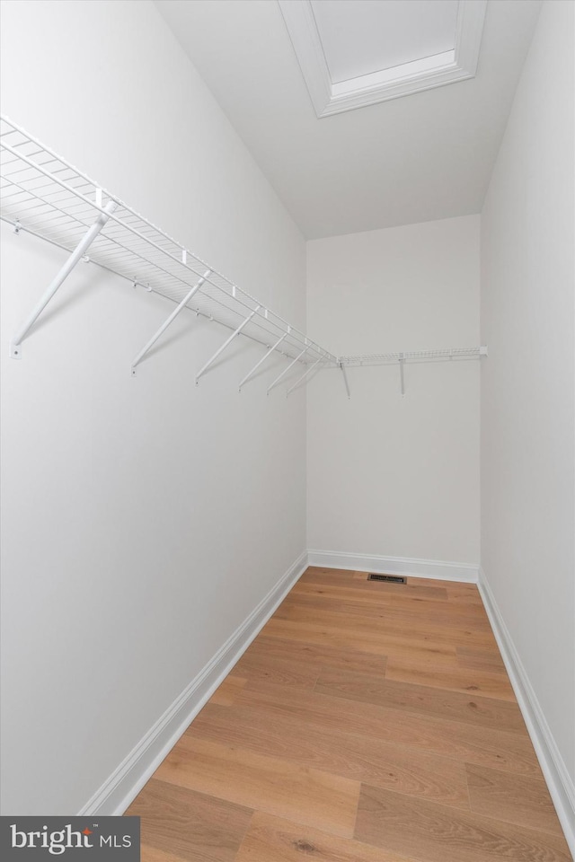 walk in closet featuring hardwood / wood-style floors