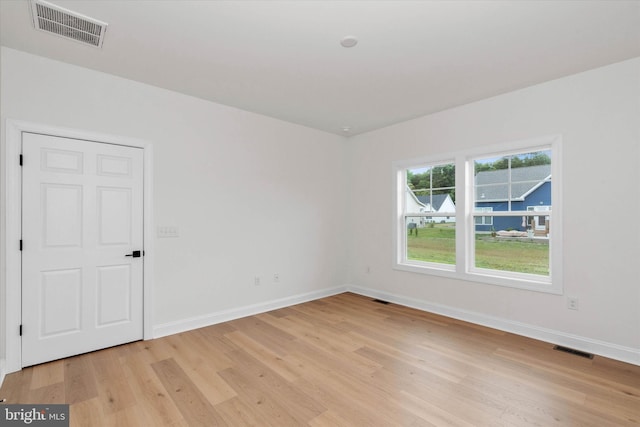 unfurnished room with light hardwood / wood-style floors