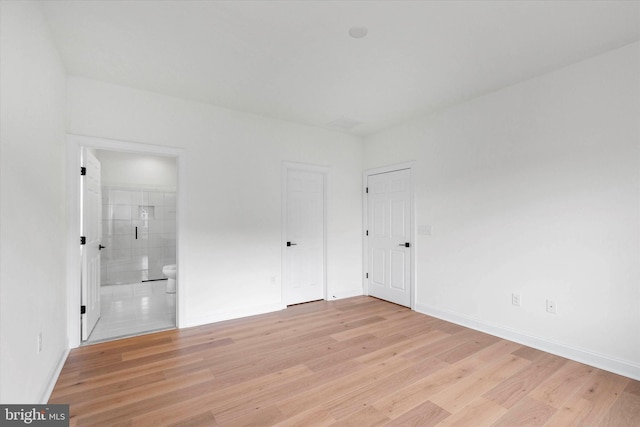 spare room with light hardwood / wood-style flooring