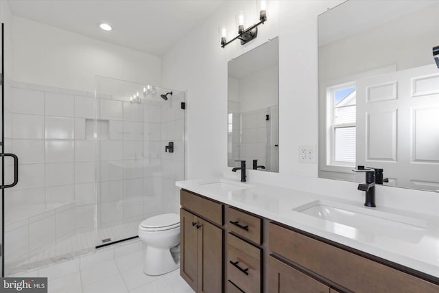 bathroom with vanity, a shower with shower door, toilet, and tile patterned flooring