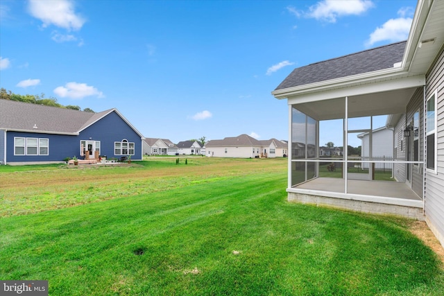 view of yard with a sunroom and a patio area