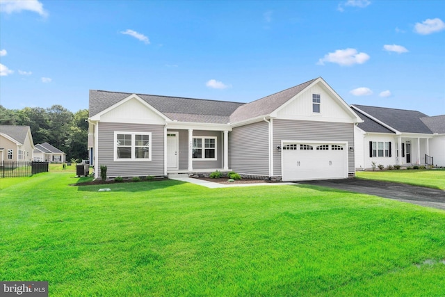 view of front of property featuring a front yard and a garage