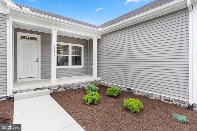 view of exterior entry featuring a porch