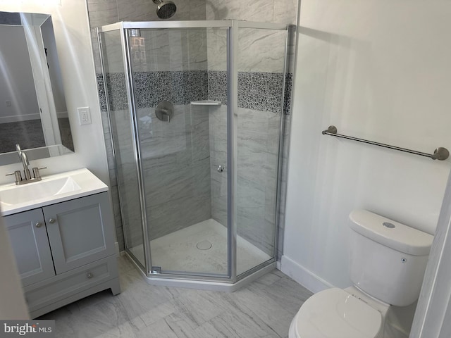 bathroom featuring walk in shower, vanity, and toilet