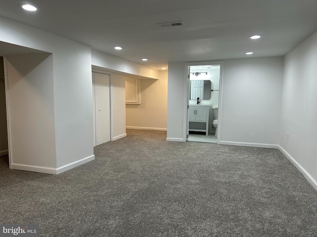 basement with dark colored carpet