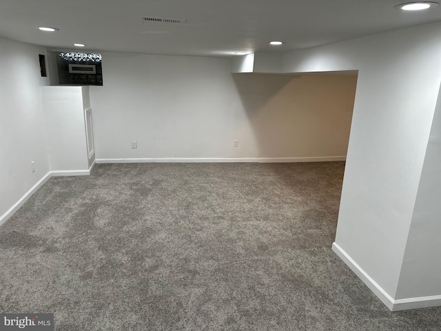 basement featuring dark colored carpet