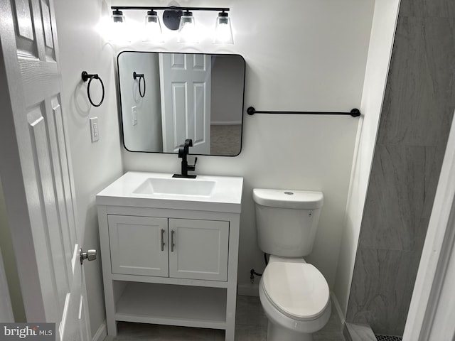 bathroom with tile patterned floors, vanity, and toilet