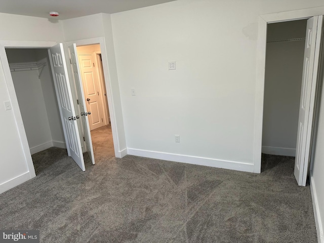 unfurnished bedroom featuring dark colored carpet