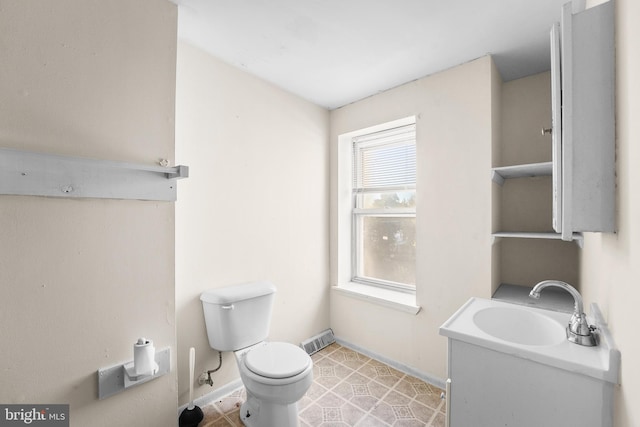 bathroom with vanity, toilet, and tile patterned flooring