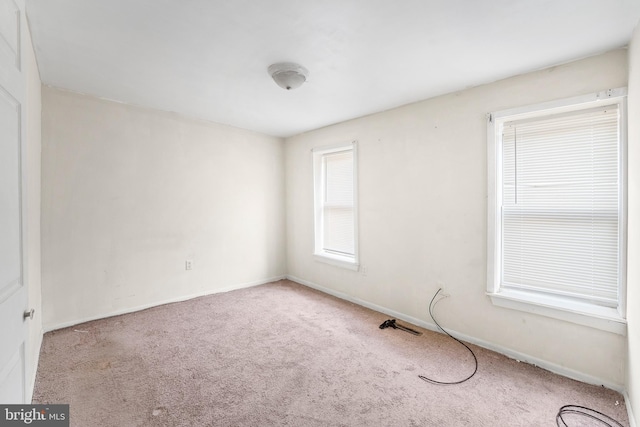 spare room with light colored carpet