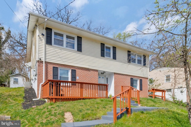 view of front facade with a front lawn and a wooden deck