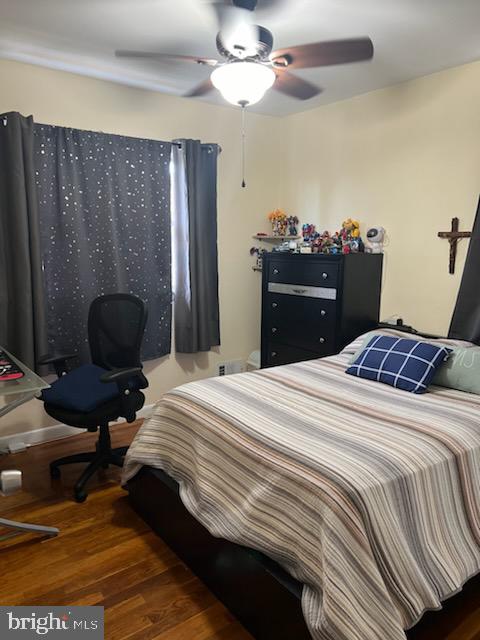 bedroom featuring ceiling fan and dark hardwood / wood-style flooring