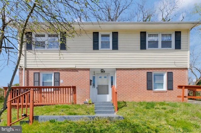 view of front of home featuring a front lawn and a deck