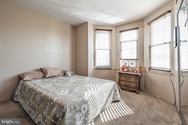 carpeted bedroom featuring multiple windows