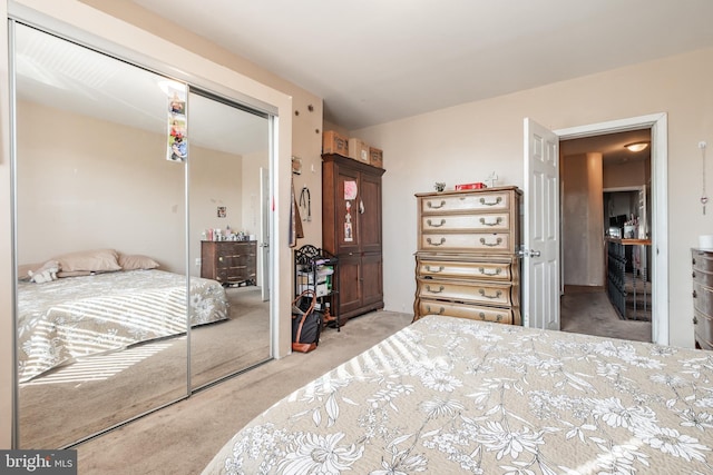 bedroom featuring a closet and light colored carpet