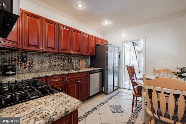 kitchen with sink, crown molding, light tile patterned flooring, appliances with stainless steel finishes, and light stone counters