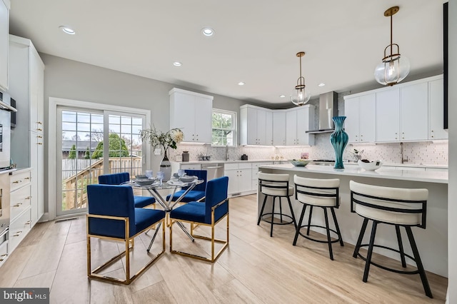 kitchen with visible vents, light wood-style flooring, white cabinets, and stainless steel appliances