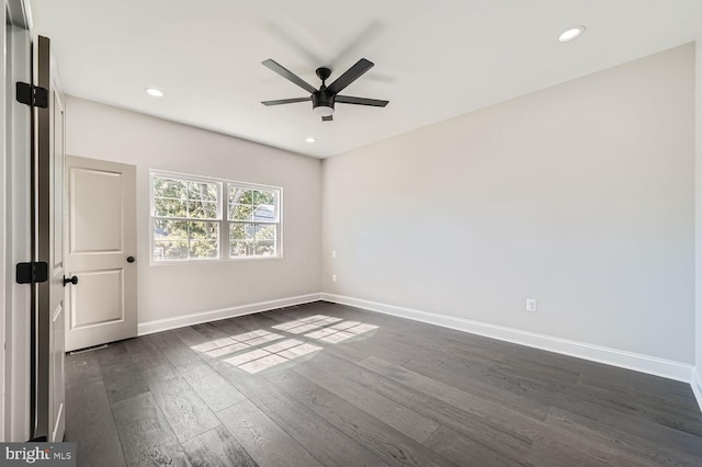 spare room featuring dark hardwood / wood-style floors and ceiling fan