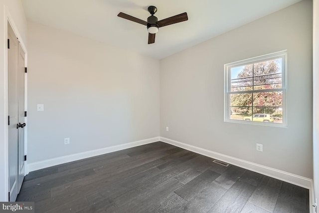 unfurnished room with ceiling fan and dark hardwood / wood-style flooring