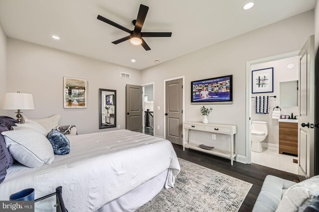empty room featuring ceiling fan, dark wood finished floors, baseboards, and visible vents