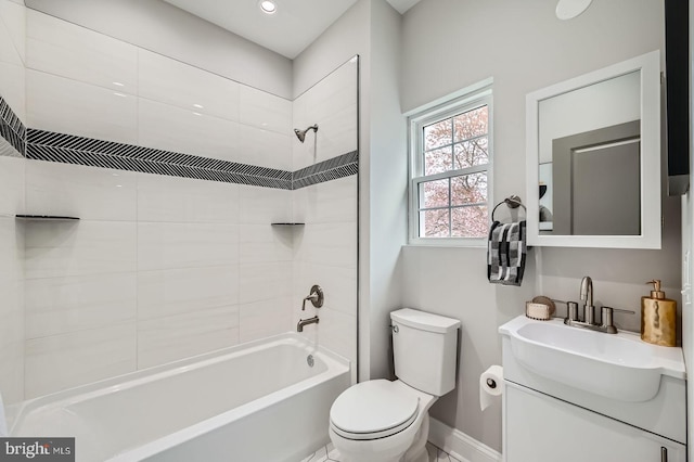 bathroom featuring baseboards, washtub / shower combination, vanity, and toilet