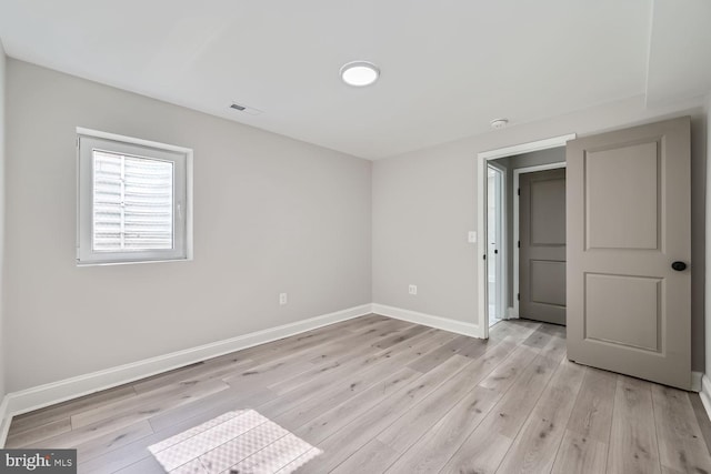 spare room featuring light hardwood / wood-style flooring