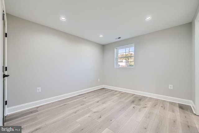 unfurnished room with light hardwood / wood-style floors