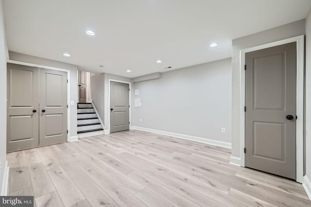 finished basement with recessed lighting, baseboards, and light wood-style floors
