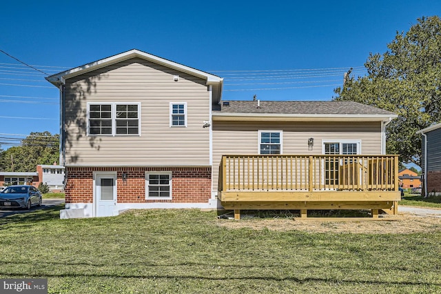 rear view of house featuring a wooden deck and a yard