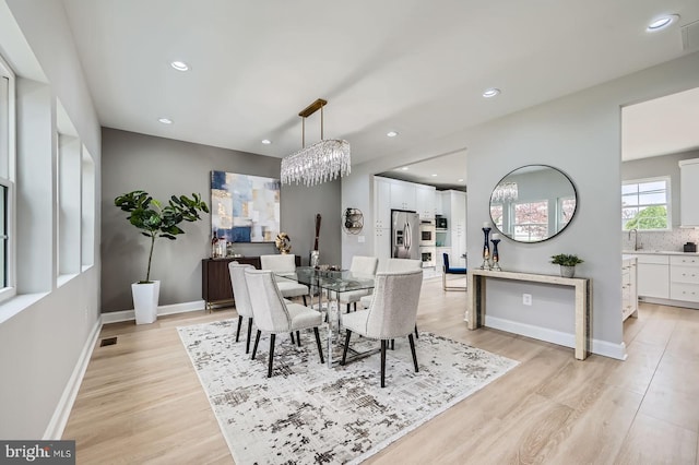 foyer entrance with stairs, baseboards, a chandelier, light wood-style floors, and recessed lighting