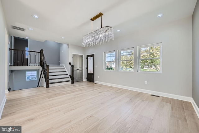 foyer featuring an inviting chandelier and light wood-type flooring