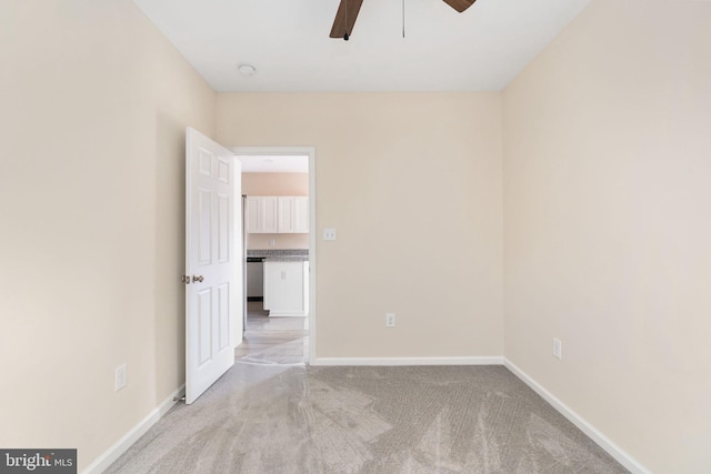 empty room with light carpet and ceiling fan