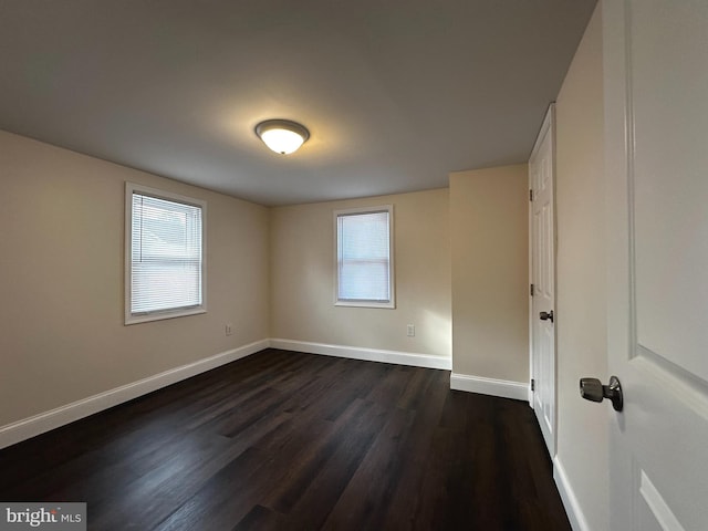 empty room featuring dark hardwood / wood-style flooring