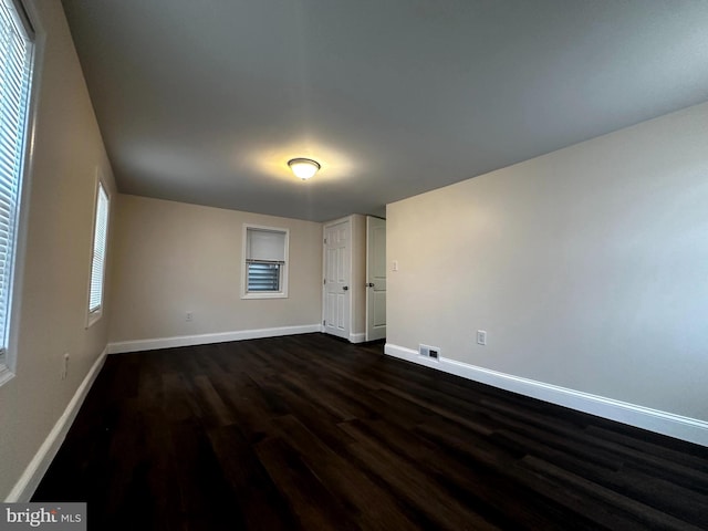 unfurnished room featuring dark hardwood / wood-style flooring