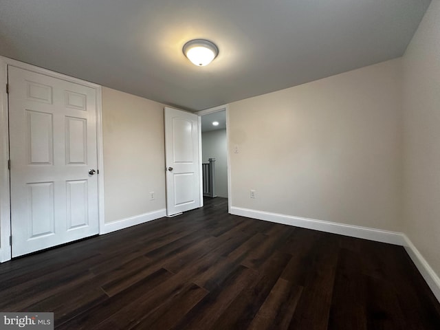 unfurnished bedroom with dark hardwood / wood-style floors